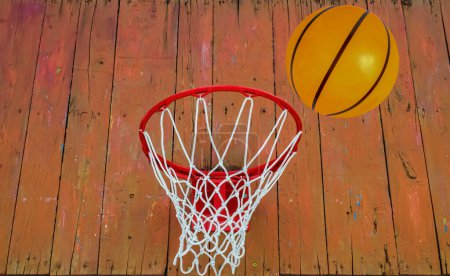 Photo for The basketball ball flies into the ring. Basketball backboard with basket and net. Goal. Orange balls in flight. Street sport. Team game. Throw the ball. The beauty. Sports business. - Royalty Free Image