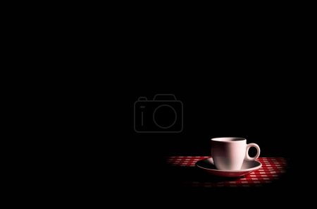 Photo for Coffee in a white cup with a saucer on a black background. Caffeine in coffee drink. Dishes for hot and cold drinks. Street Cafe. Caffeine in a drink. The beauty. Catering business. - Royalty Free Image