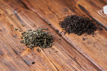 Photo for Tea bag, green and black tea on an old wooden table. - Royalty Free Image