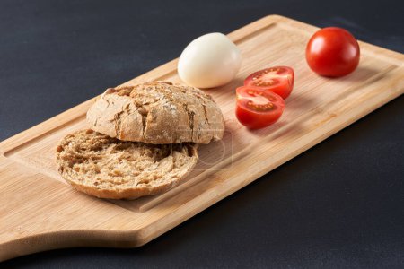 Photo for Sandwiches with tomatoes, eggs and mayonnaise on a wooden plate. - Royalty Free Image