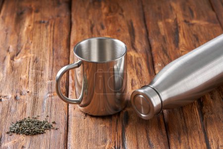 Photo for Stainless steel mug on an old wooden table. - Royalty Free Image