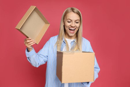 Concept of delivery, young woman look in to box