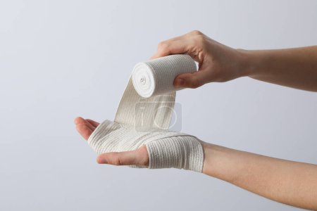 Photo for Concept of hand injury help with elastic bandage - Royalty Free Image