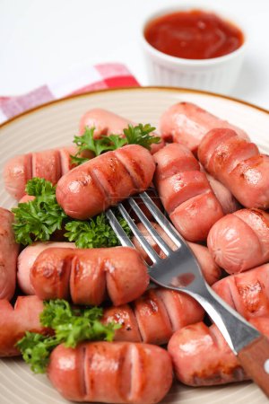 Concept of tasty food, grilled mini sausage, close up