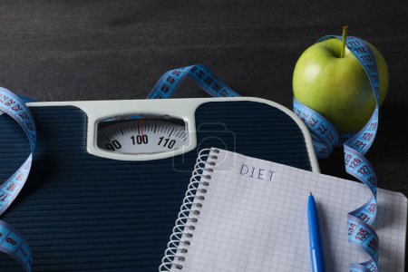 Photo for Concept of weight loss and healthy nutrition with apple and measuring tape - Royalty Free Image