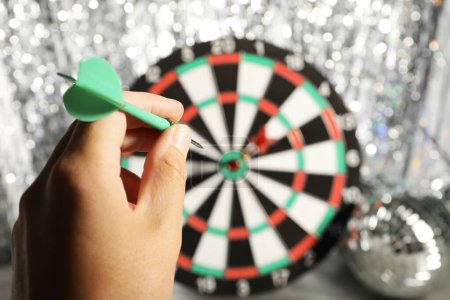 Photo for Darts hitting the target game at the party. - Royalty Free Image