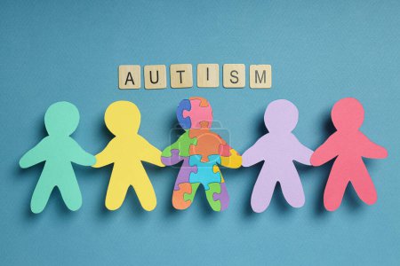 Photo for Paper figures of people on a light background. World autism day concept - Royalty Free Image