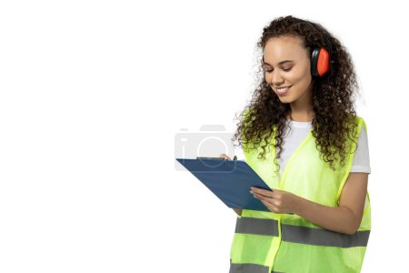 Photo for A girl in noise-absorbing headphones and a folder, isolated on white background - Royalty Free Image