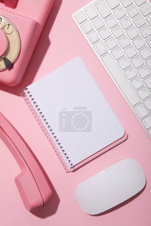 Photo for Vintage phone, keyboard and notepad on pink background, top view - Royalty Free Image