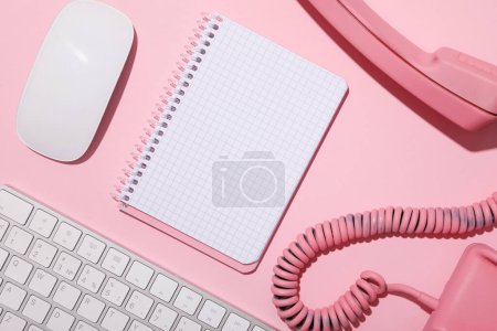 Photo for Vintage phone, keyboard and notepad on pink background, top view - Royalty Free Image