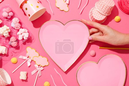 Photo for Confectionery molds, candies and female hand on pink background, top view - Royalty Free Image
