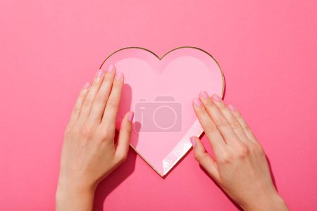Photo for Decorative heart and female hands on pink background, top view - Royalty Free Image
