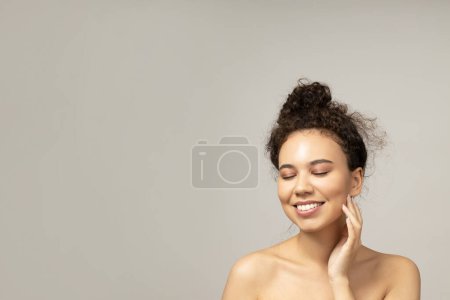 Photo for An attractive girl takes care of her facial skin - Royalty Free Image