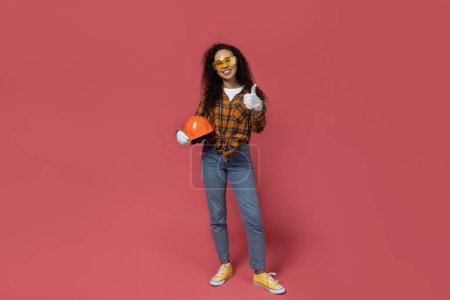 Photo for A girl in construction glasses and a helmet in her hands - Royalty Free Image