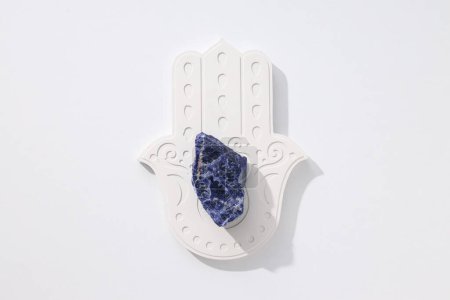 Photo for Hamsa and natural stone on white background, top view - Royalty Free Image