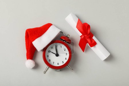 Photo for A clock with a Santa hat with a New Year's decoration. - Royalty Free Image