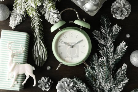Photo for A clock with a New Year's decoration, on a dark background. - Royalty Free Image