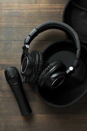 Photo for Black, large headphones, on the table with a microphone. - Royalty Free Image