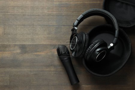 Photo for Black, large headphones, on the table with a microphone. - Royalty Free Image