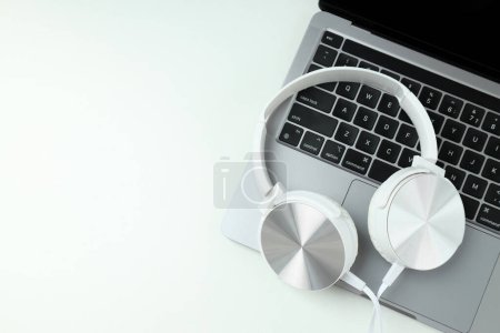 Photo for Big headphones, on a table with a laptop. - Royalty Free Image