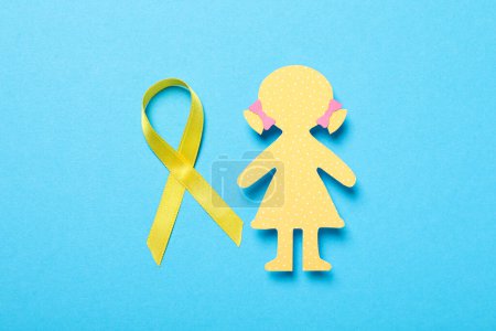 Téléchargez les photos : Une figure en papier d'une fille avec un ruban jaune - en image libre de droit