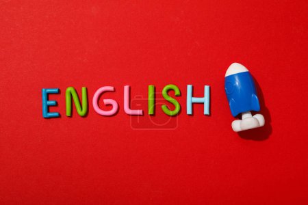 The word English with a rocket next to it, on a red background.