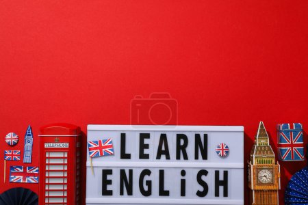 Blackboard with the inscription "English lessons" on a red background.