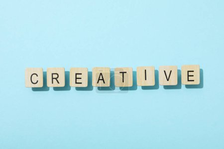 Das Wort: "kreativ" in Buchstaben auf blauem Hintergrund.