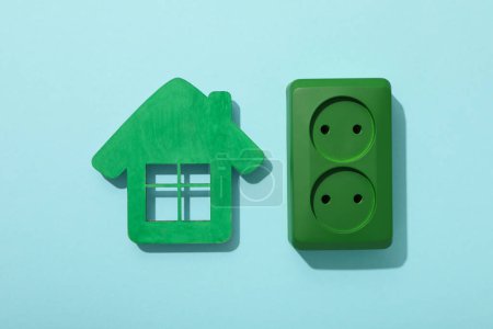 Decorative house with a green electrical outlet