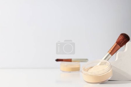 Photo for Face powder with a brush, on a light background. - Royalty Free Image