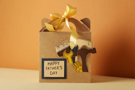 A gift for father, for the holiday, on an orange background.