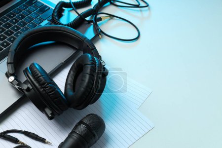 Photo for Big headphones, on a table with a laptop. - Royalty Free Image