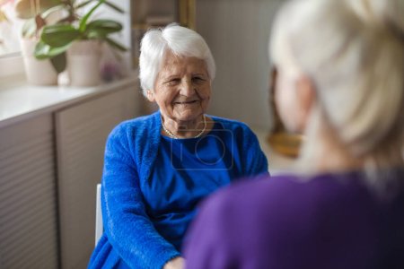 Foto de Mujer pasando tiempo con su anciana madre en casa - Imagen libre de derechos