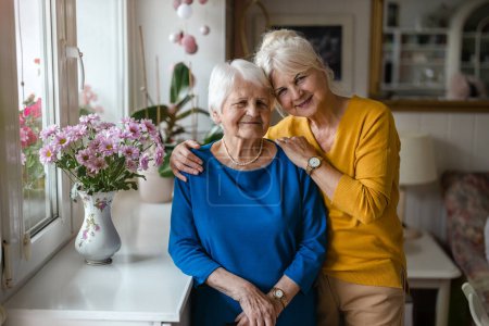 Photo for Woman hugging her elderly mother - Royalty Free Image
