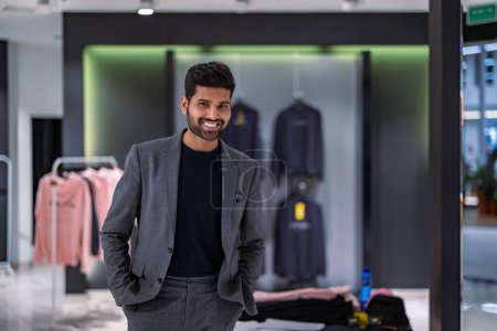 Photo for Young man shopping in clothing store - Royalty Free Image