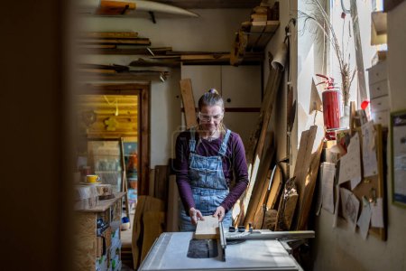 Photo for Craftswoman working with wood in carpentry workshop - Royalty Free Image