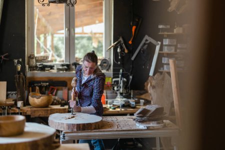 Photo for Craftswoman working with wood in carpentry workshop - Royalty Free Image
