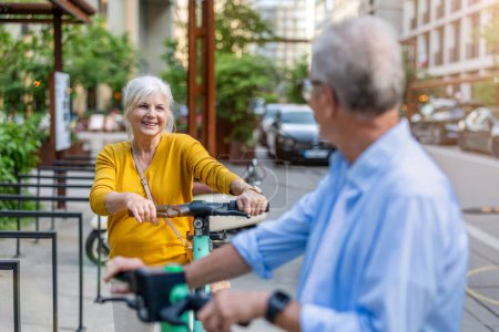 Photo for Senior couple riding electric scooters in the city - Royalty Free Image