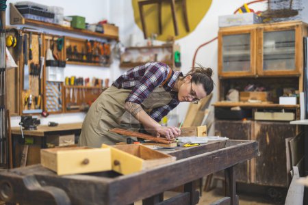 Photo for Female carpenter working in her workshop - Royalty Free Image