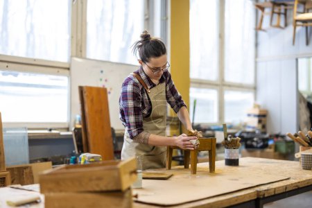Photo for Female carpenter working in her workshop - Royalty Free Image