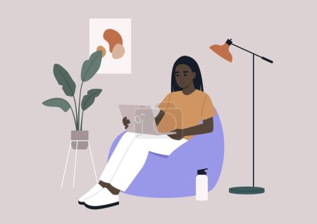 an African hipster character sits on a bean bag while typing on their laptop in their home office