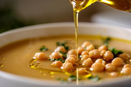 Creamy chickpea soup drizzled with extra virgin olive oil