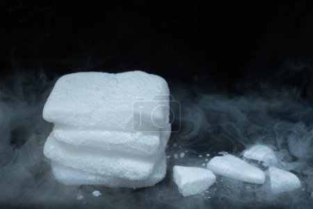 Photo for Dry ice cubes stacked on black background - Royalty Free Image