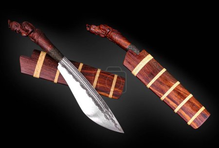 Photo for Amulet knife of Native Thailand knife with tamarind core wood sheath and carving hermit handle is handmade in Thailand for protection luckily - Royalty Free Image