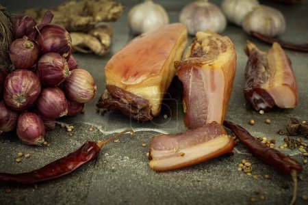 Photo for Yunnan bacon pork on a stone plate with spices sitting - Royalty Free Image