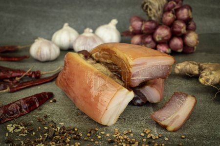 Photo for Yunnan bacon pork on a stone plate with spices sitting - Royalty Free Image