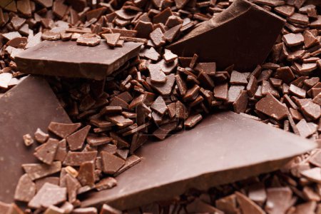 Photo for Pieces of broken chocolate in chocolate chips close-up. Chocolate background. - Royalty Free Image