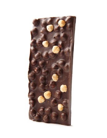 Foto de Una barra entera de chocolate negro hecho a mano con avellanas aisladas sobre un fondo blanco. - Imagen libre de derechos
