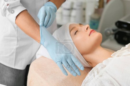 Photo for Hands in medical gloves are preparing for the cosmetic procedure. The beautician puts on gloves before taking botox injections. - Royalty Free Image