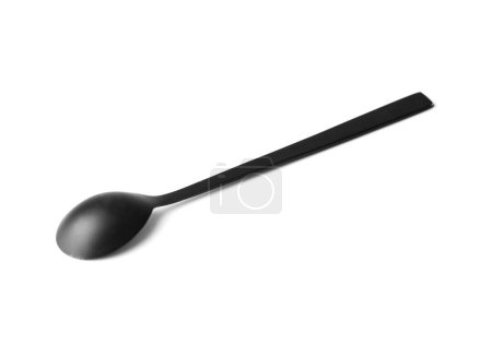 Foto de Cuchara negra de metal mate con mango largo sobre fondo blanco, cuchara de café, cubiertos negros sobre blanco aislado. - Imagen libre de derechos